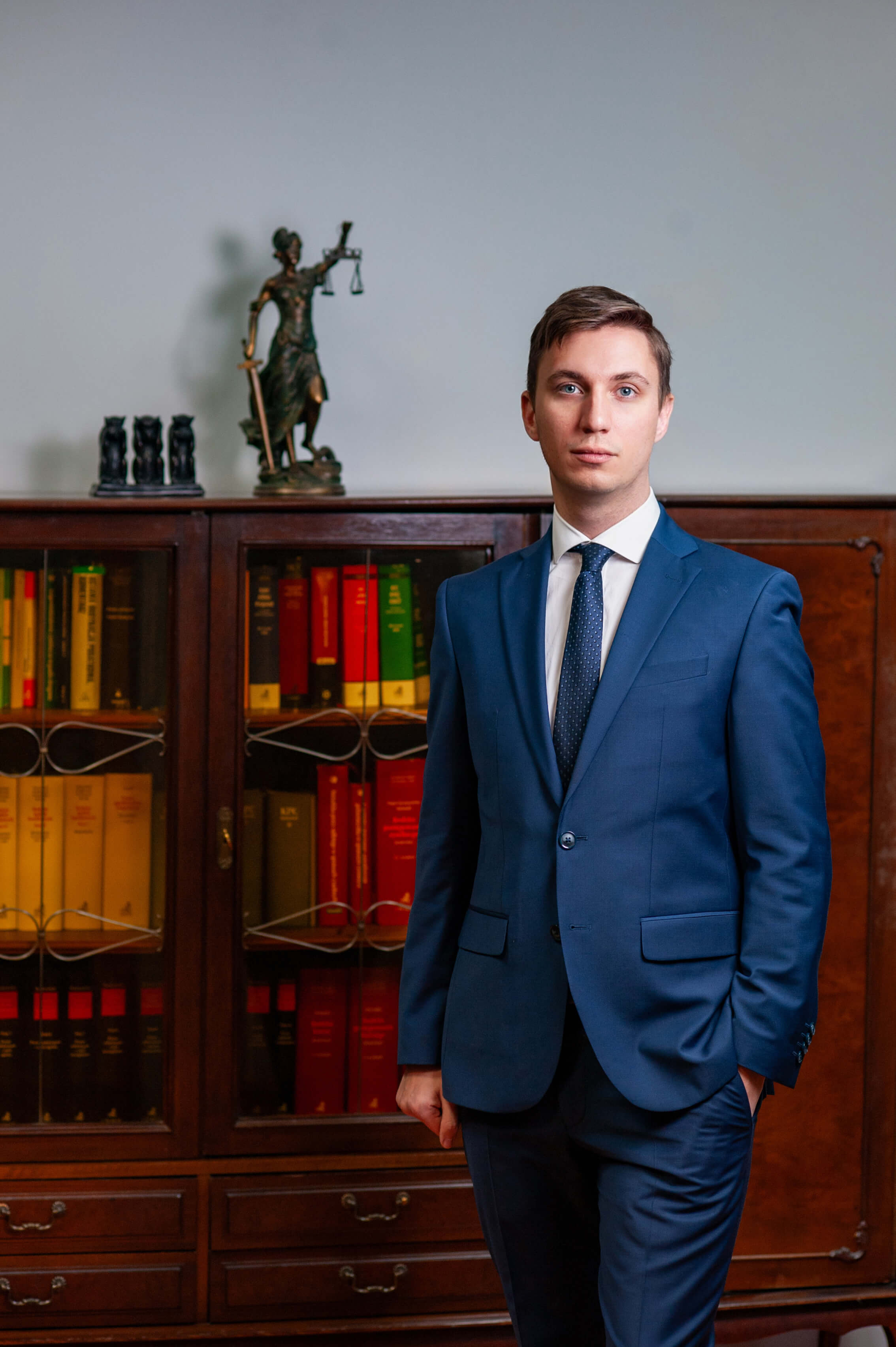 Attorney in formal attire standing in a law office